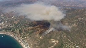 Archival aerial view of a brush fire in Malibu hills; this is not a photograph of the October 2026 Bryson Fire