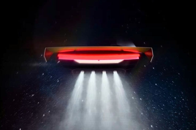 Tesla Roadster rear teaser showing a red light bar and four thruster-like outlets