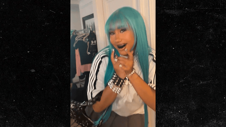 North West showing blue hair and black grills in a TikTok fashion look