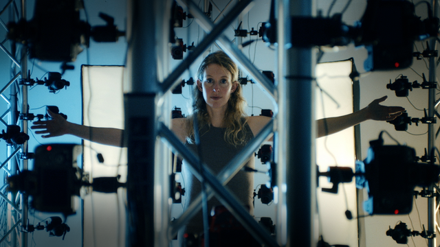 Official You Can See Everything documentary still featuring Elizabeth Holmes in a multi-camera rig