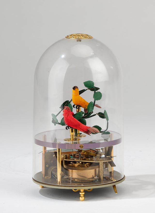 Illustrative historic singing-bird automaton under a glass dome; not identified as the $2,000 German item mentioned in the Kelly Clarkson story