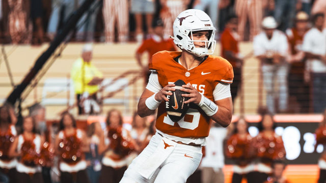 Texas Longhorns quarterback Arch Manning scans the field during a game